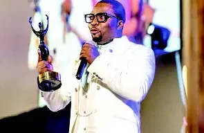 Frank Rajah on stage for his award