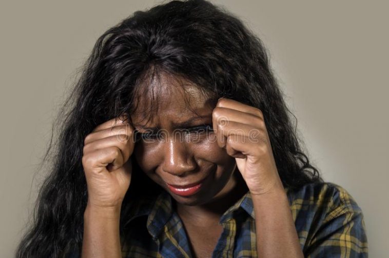 young sad depressed black african american woman crying anxious overwhelmed feeling sick stressed isolated studio b 127611147