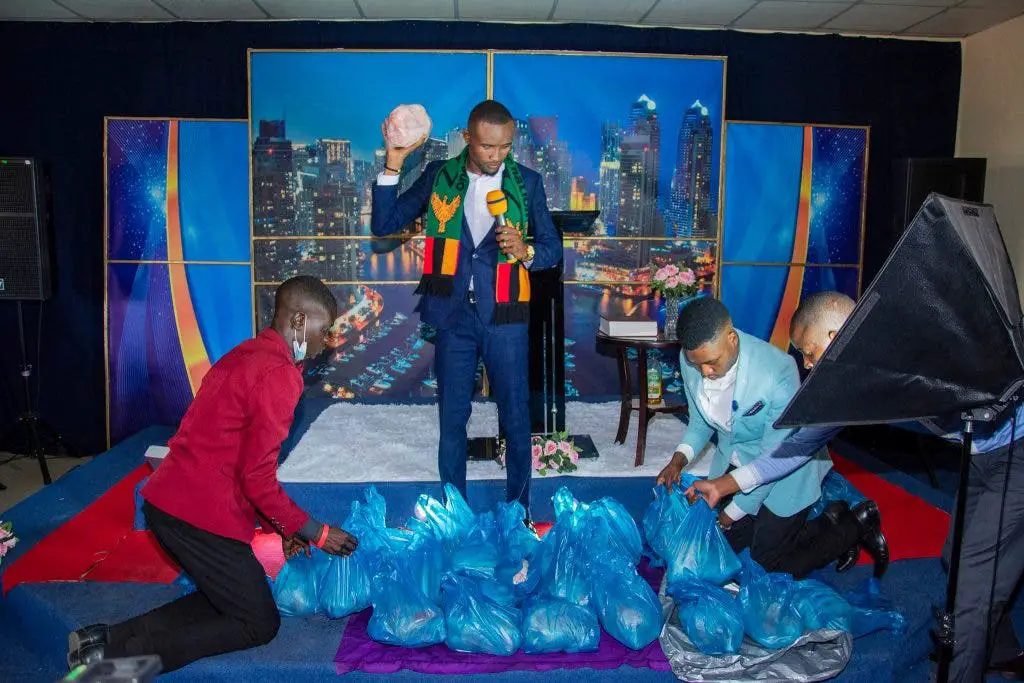 Church members kneel down to welcome their pastor 1 1024x683 1