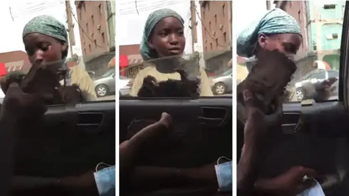 Child beggar rejects bundle of money offered to her by young man in a car (Watch video)